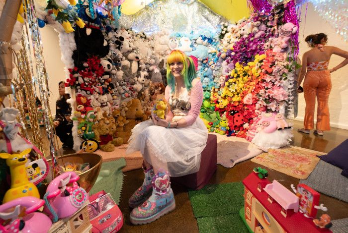 The Opening Event of  A Tra$shy Dreamland - Artist Moon Girle is sitting inside of the installation